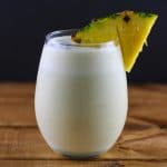 a glass of coconut pineapple matcha smoothie