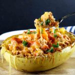 buffalo chicken spaghetti squash with someone pulling up a bite on a fork