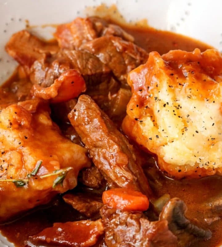 a bowl of Guinness beef stew with garlic cheddar dumplings