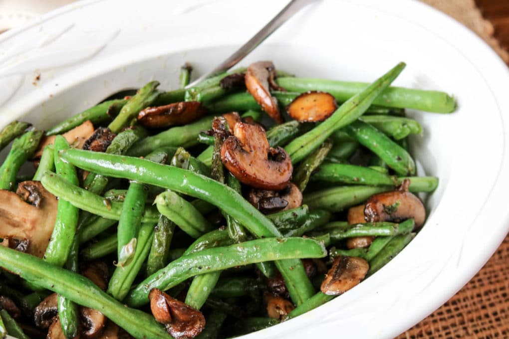a dish of sautéed green beans and mushrooms