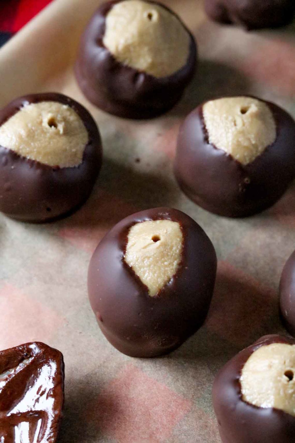 several Sunbutter Buckeyes on a sheet of parchment paper