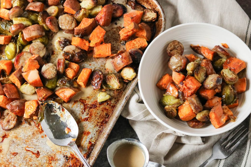 pan-roasted vegetables and sauste on a sheet pan and served in a white bowl with maple tahini