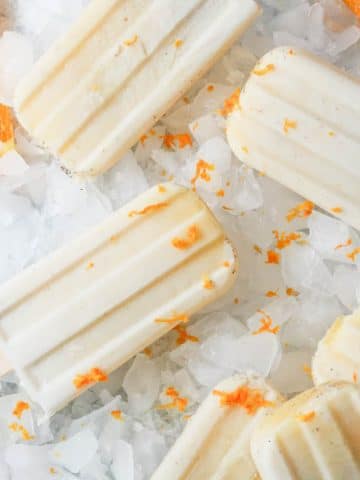 Orange Cardamom Creamsicles laying on ice
