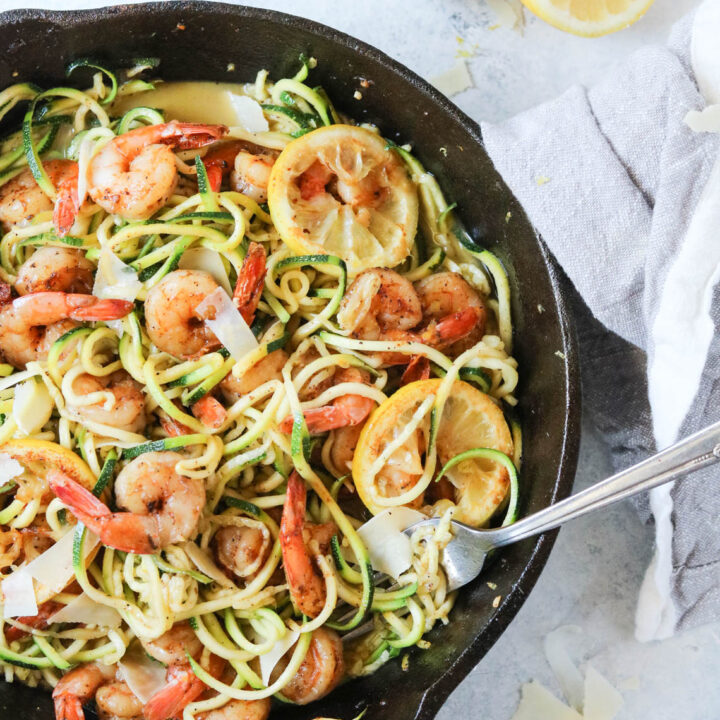 blackened lemon shrimp with zucchini noodles in a cast iron skillet