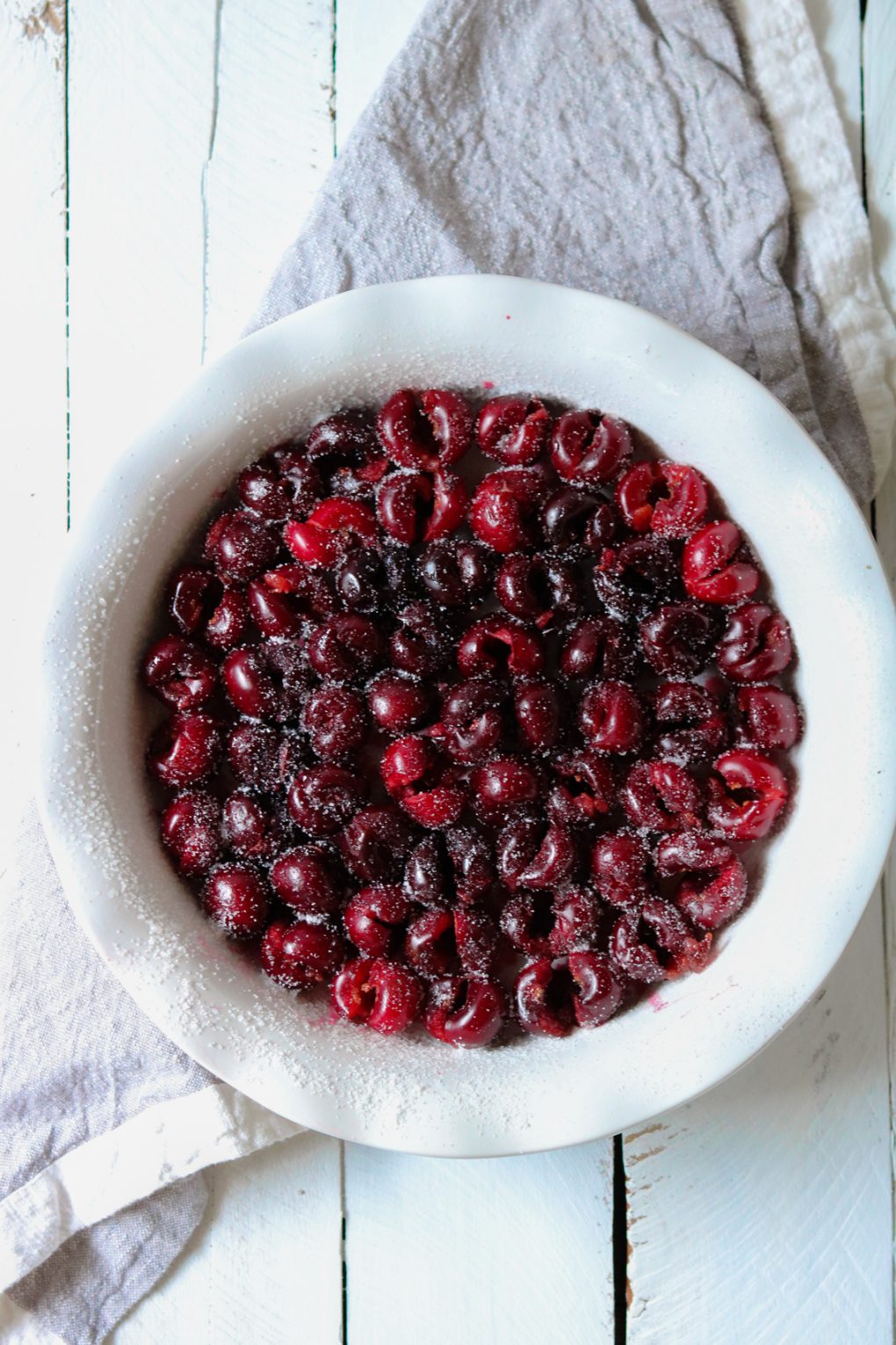 fresh cherries lining the bottom of a pie plate