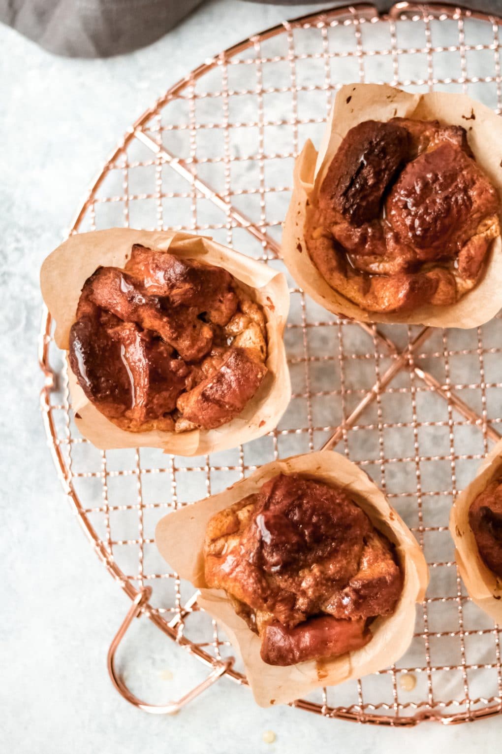 three french toast muffins sitting on a cooling rack