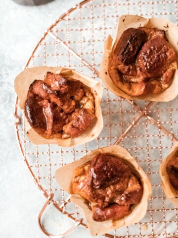 three french toast muffins sitting on a cooling rack