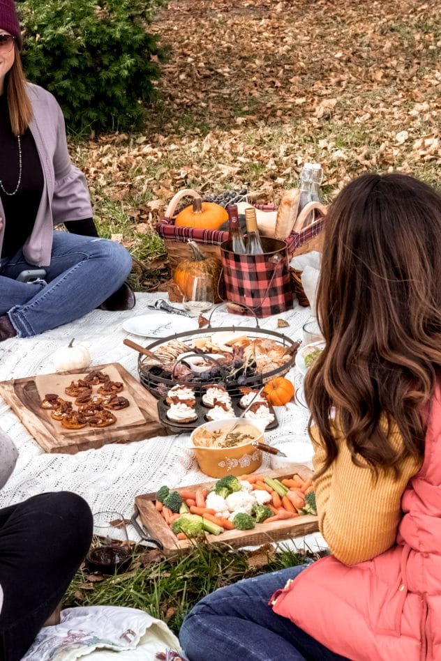 an outdoor fall picnic scene for friendsgiving