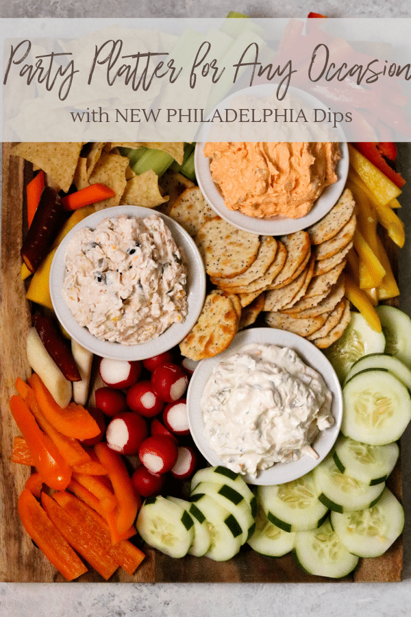 a party platter with fresh vegetables and chips and three varieties of the NEW PHILADELPHIA dips
