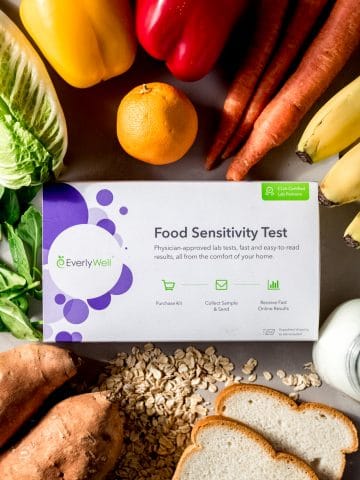 An EverlyWell Food Sensitivity test box surrounded by a variety of fresh food