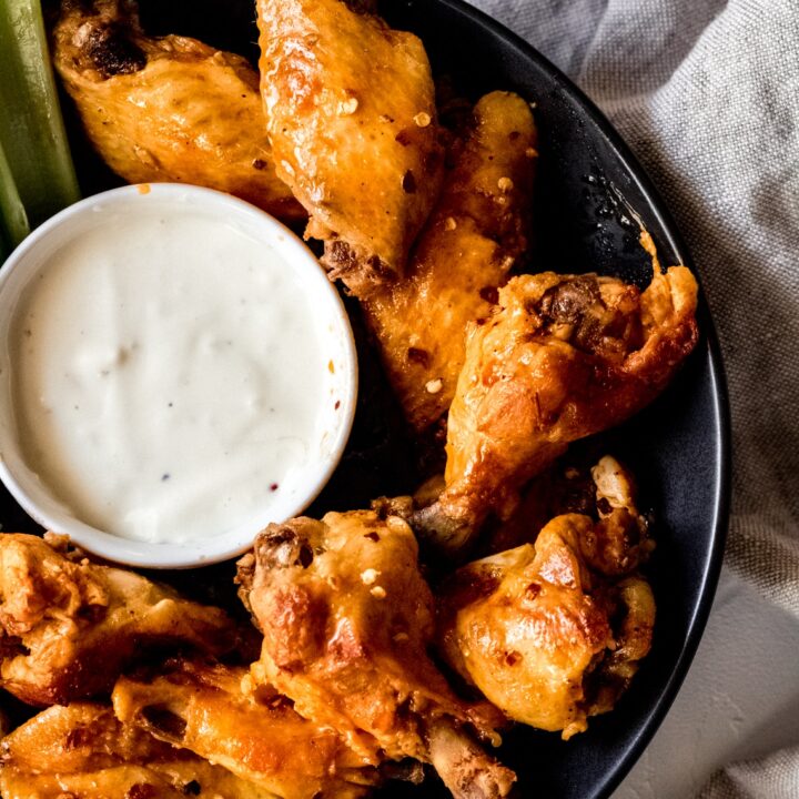 a bowl of chicken wings with blue cheese sauce