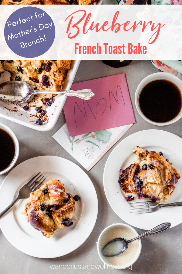 a table spread featuring blueberry french toast bake, two servings on white plates, two cups of coffee and a mother's day card