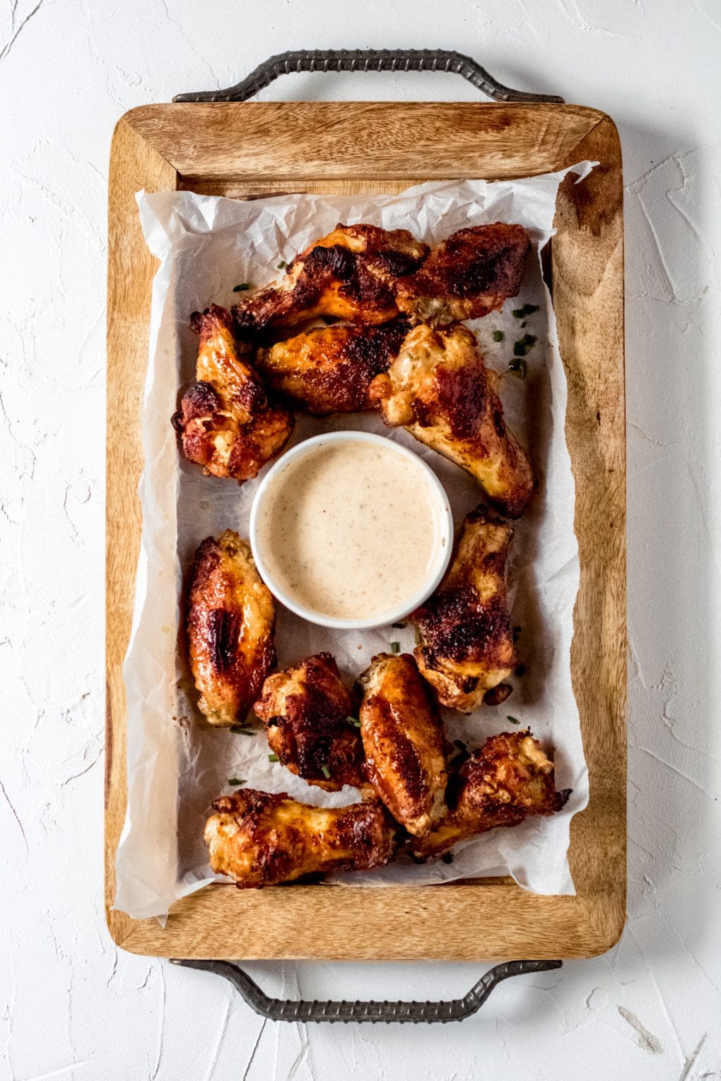 a tray of cajun chicken wings with cajun ranch dressing