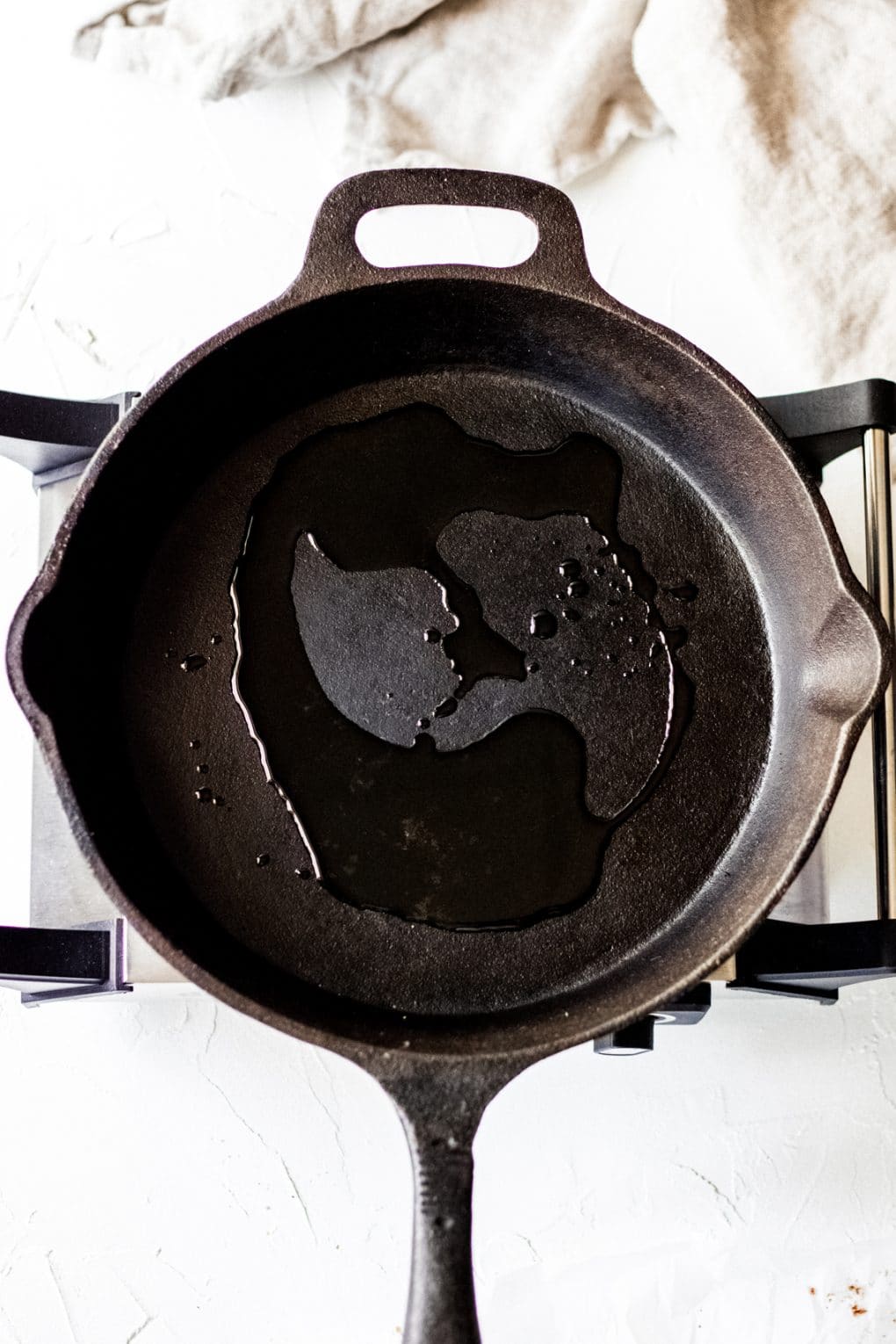 oil heating up in a cast iron skillet