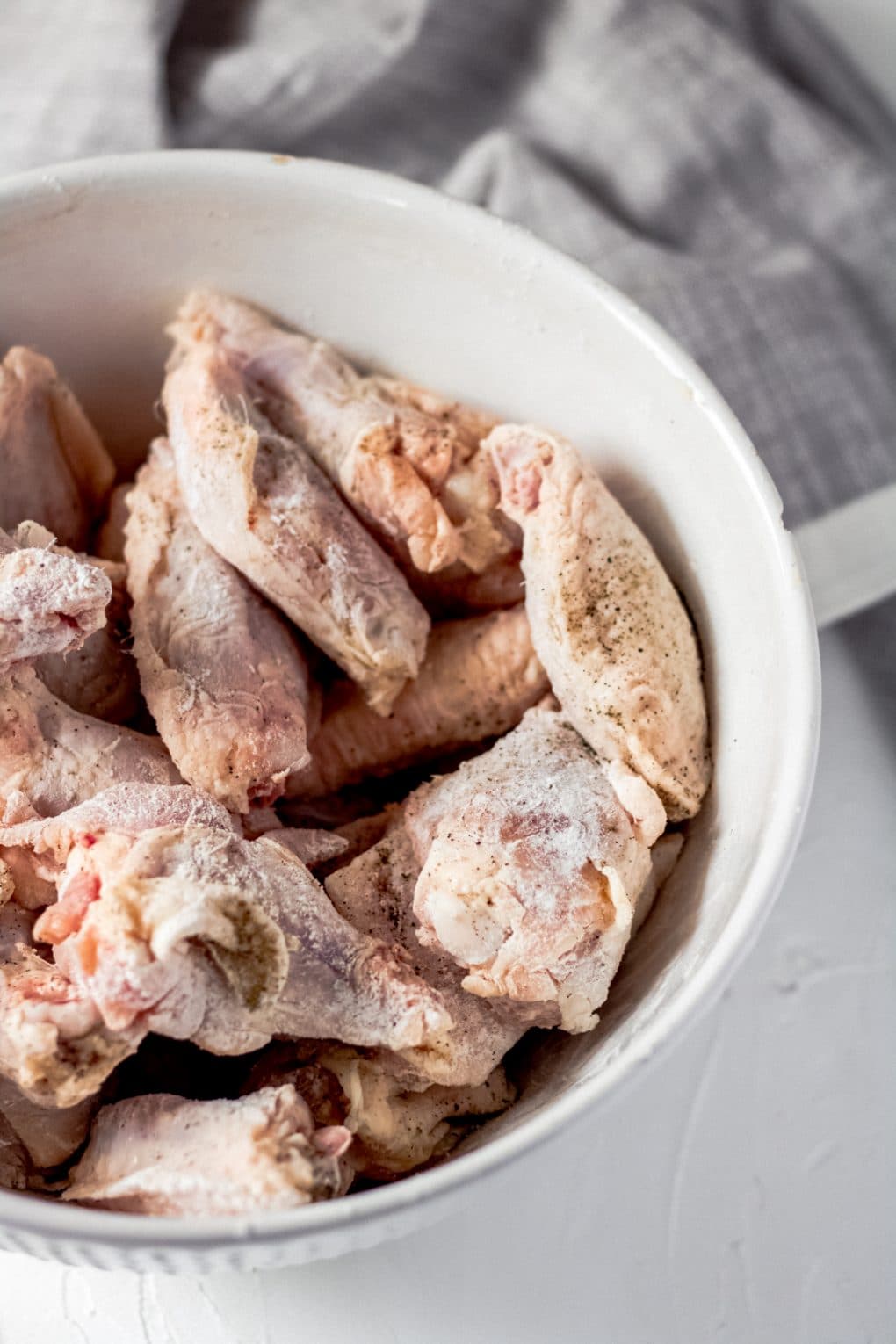 a bowl of raw chicken wings
