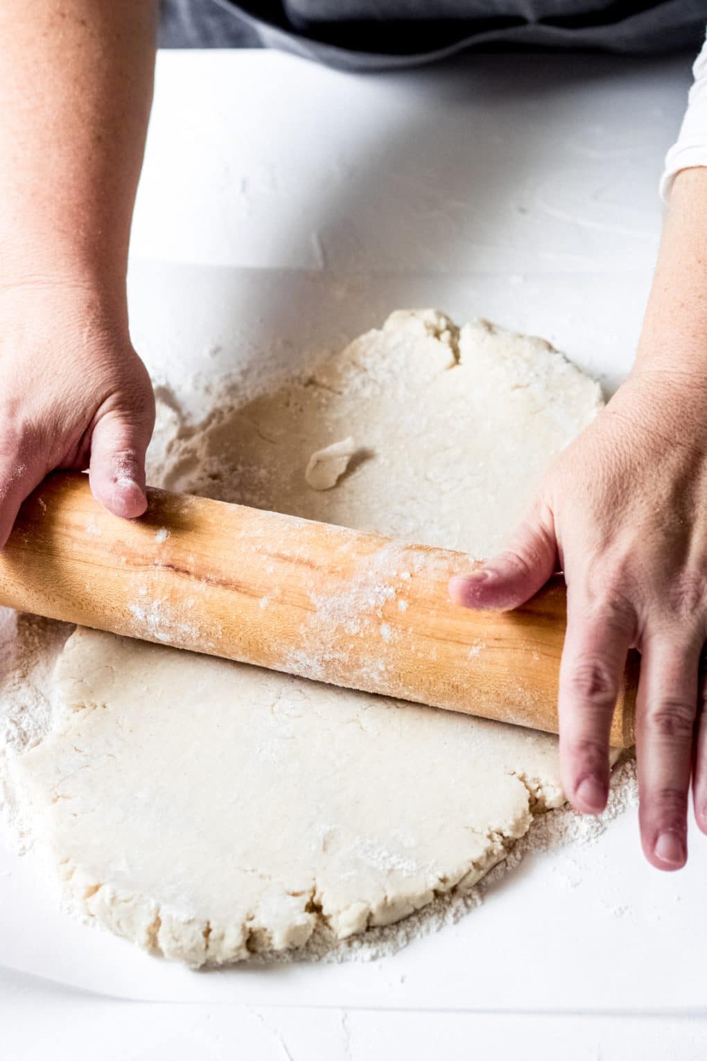 a woman rolling out gluten-free galette dough