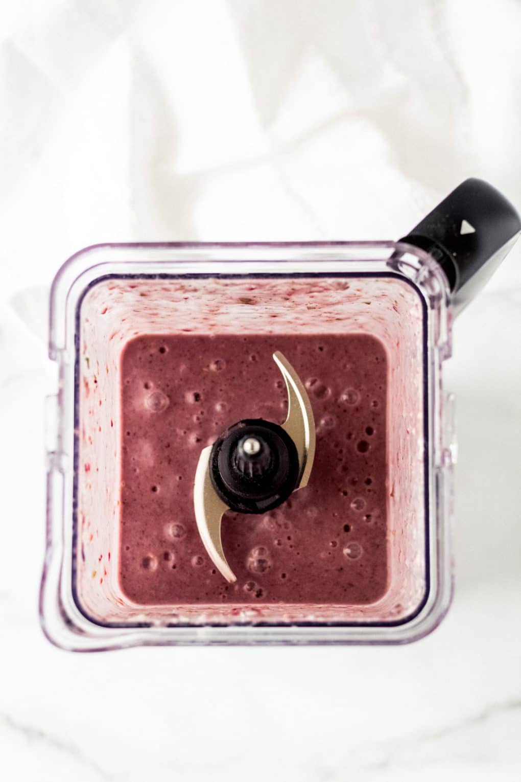 a berry bone broth smoothie in a blender