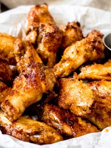 a bowl of gluten-free chicken wings with maple syrup