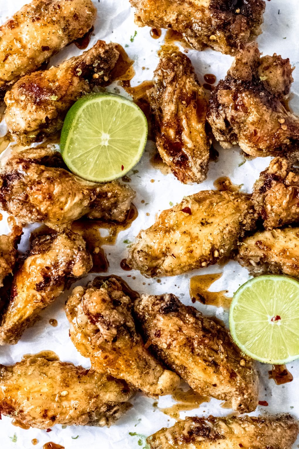 honey lime chicken wings with two lime wedges