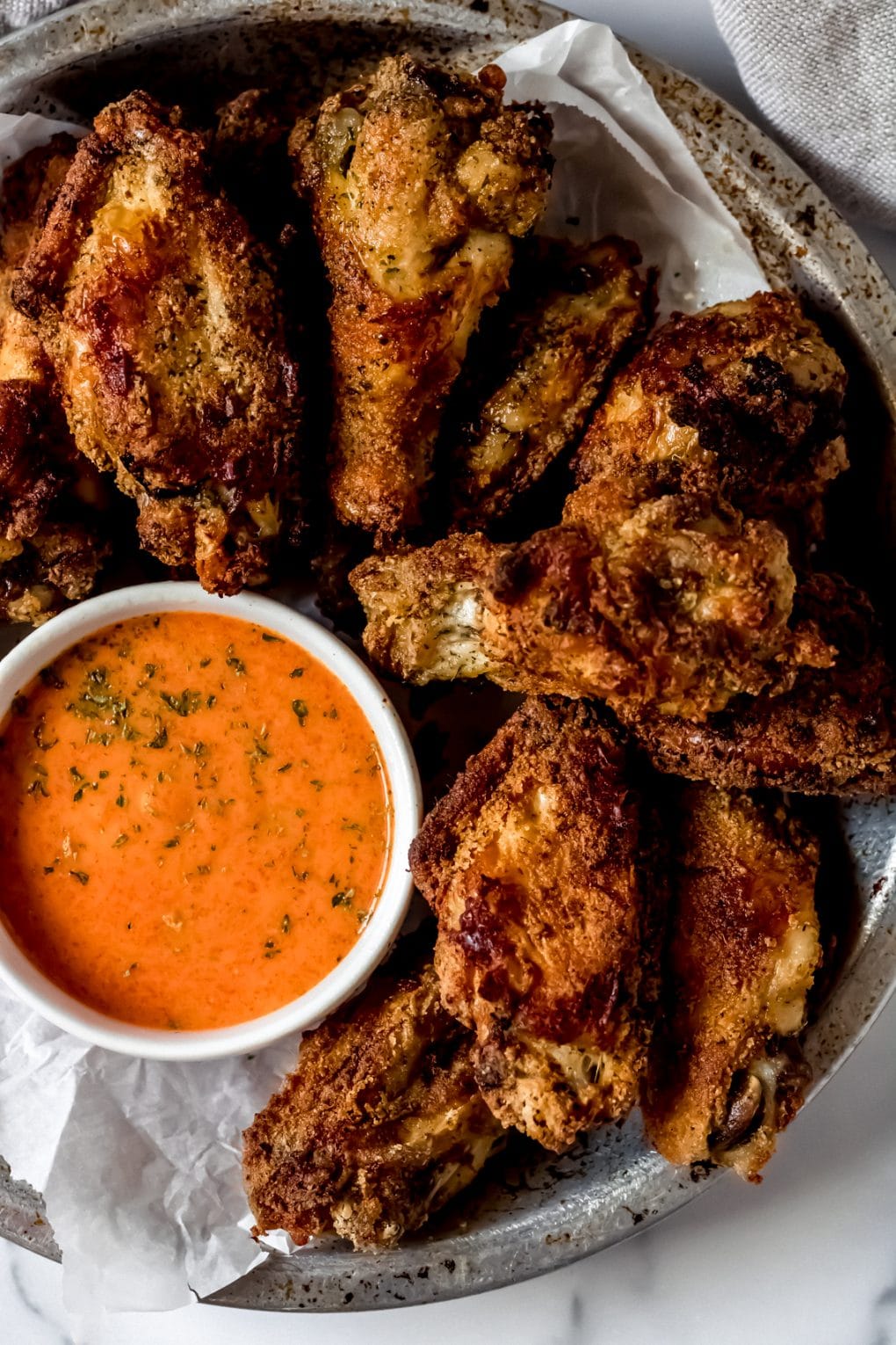ranch chicken wings with a bowl of buffalo ranch wing sauce