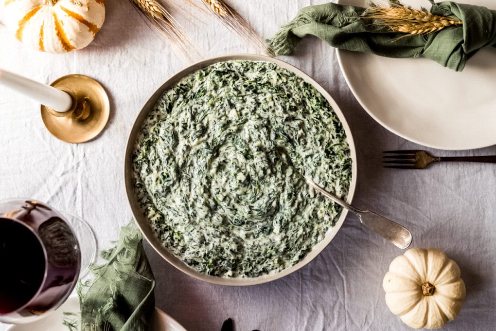 a bowl of creamed spinach on a dinner tablescape 