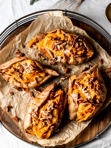 four maple pecan twice-baked sweet potatoes on a round serving platter