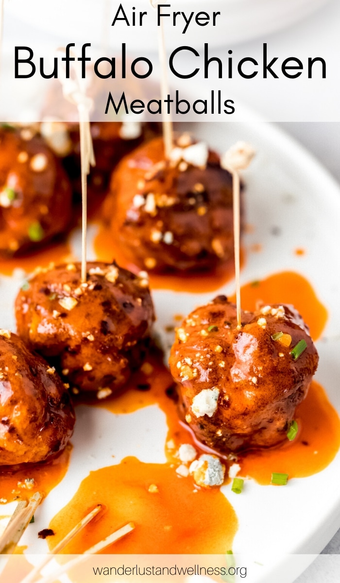 air fryer buffalo chicken meatballs on a white plate with serving toothpick in them