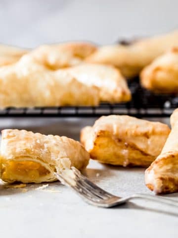 air fryer apple turnovers with one cut open with a fork