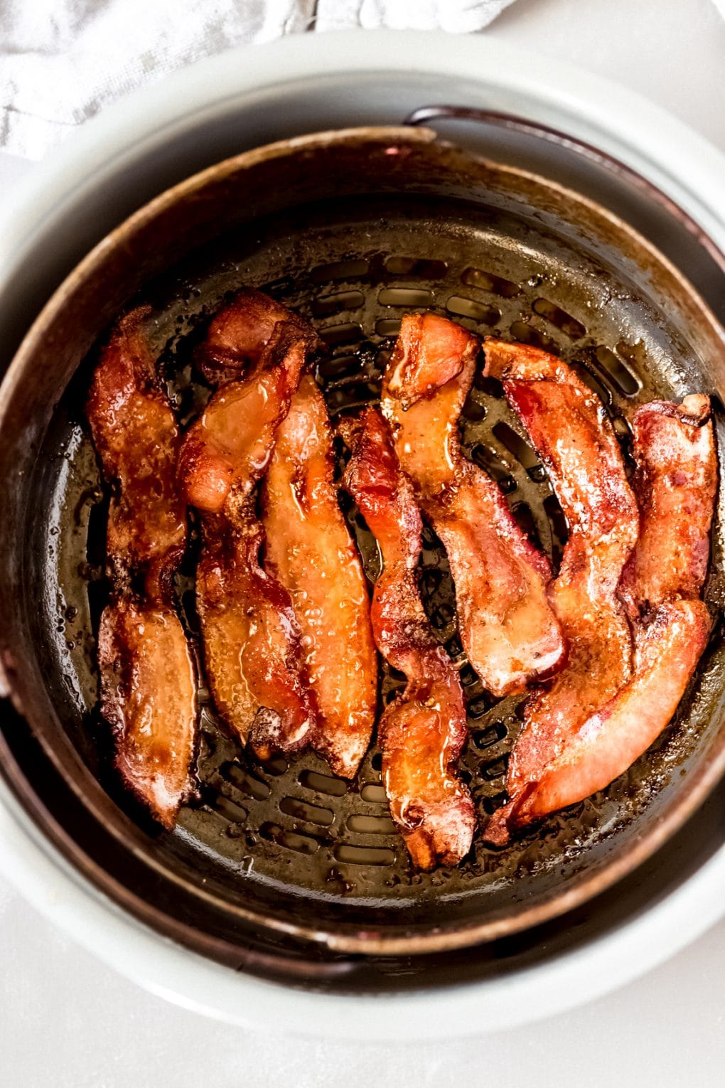 cooked air fried candied bacon in an air fryer basket