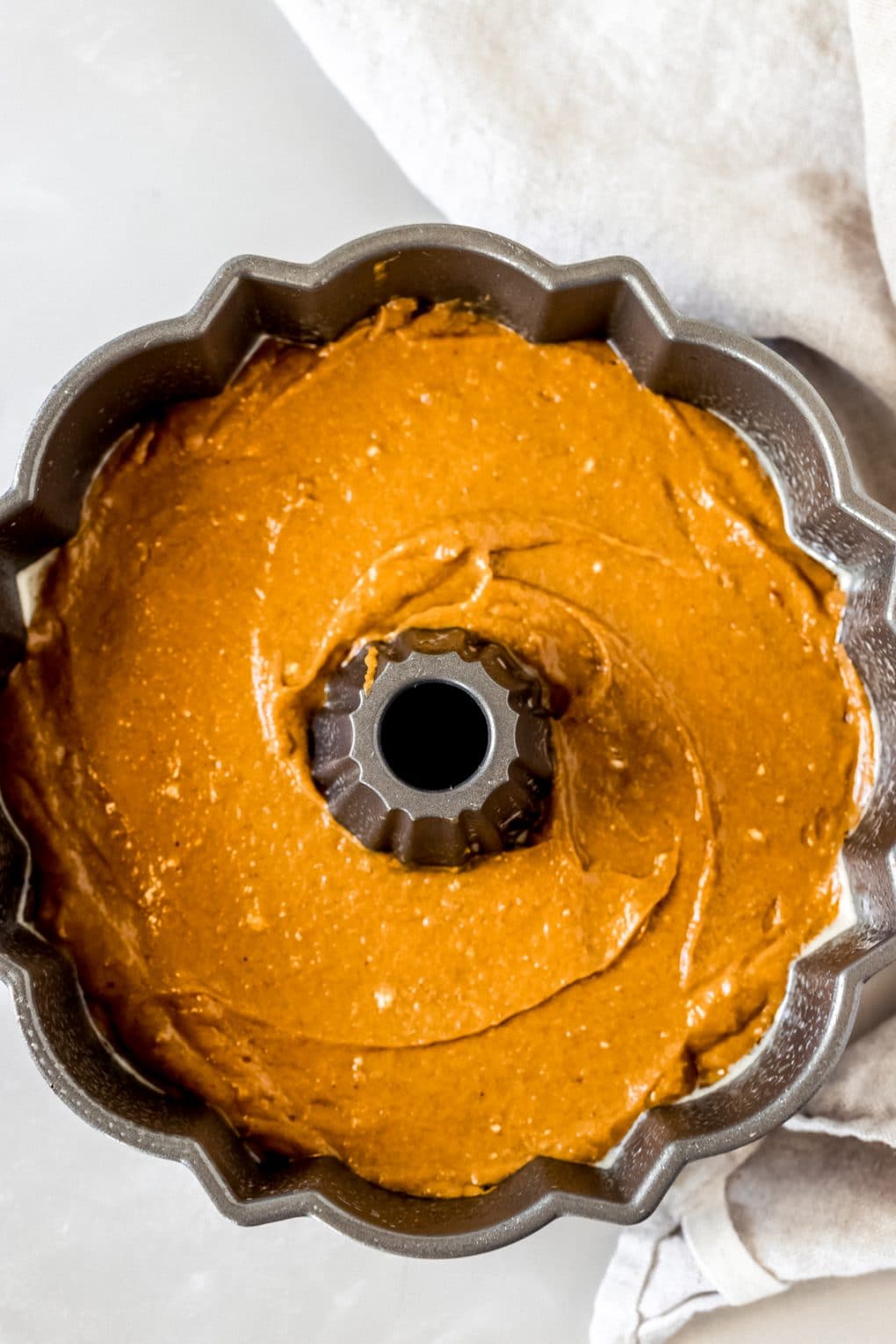 batter for a pumpkin spice bundt cake in a bundt pan