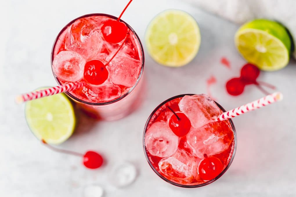 an overhead shot of two cherry lime la croix cocktails
