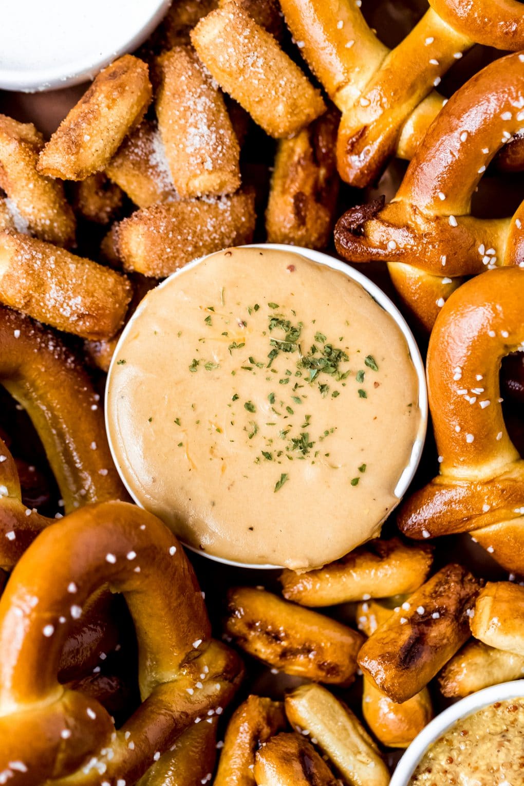 Guinness cheese dip on a soft pretzel snack board