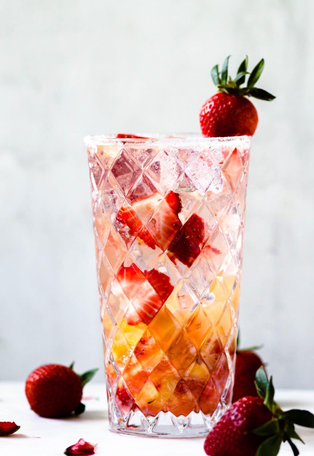 a highball glass with a pineapple strawberry la Croix cocktail