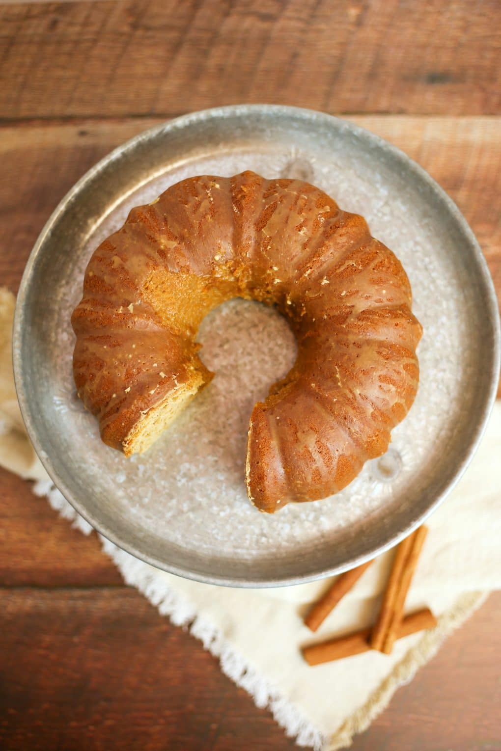 close up of bundt cake with one piece cut out 