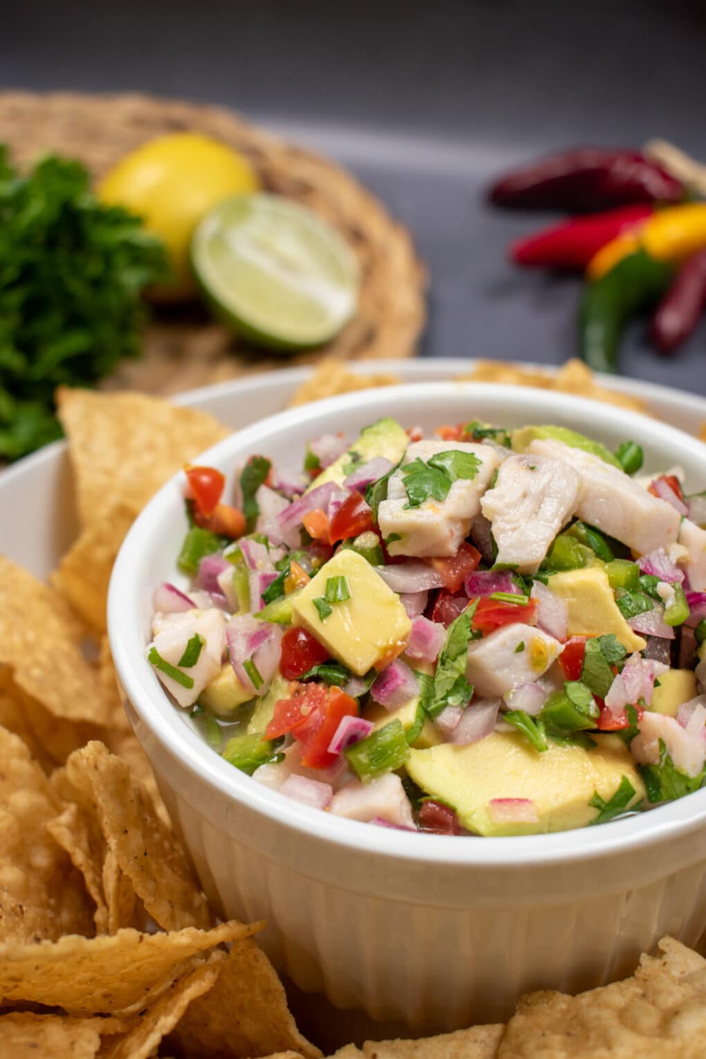 Mahi Mahi Ceviche in a bowl in the middle of a plate of tortilla chips