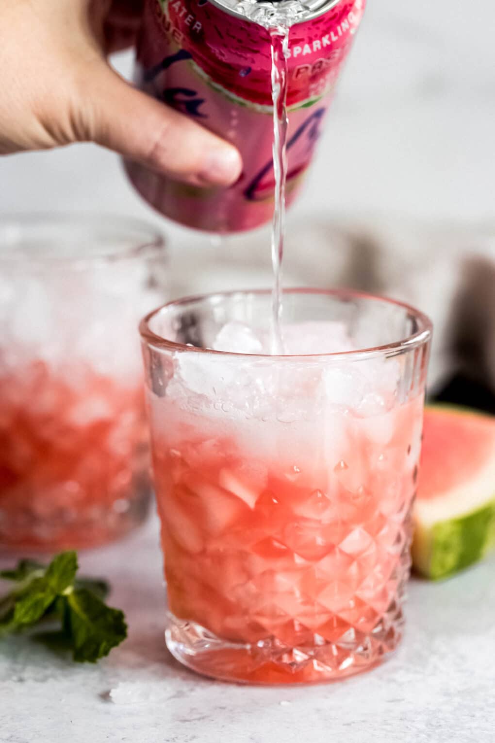 Woman adding Watermelon La Croix to cocktail glass